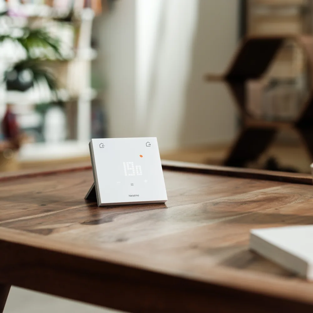 The wireless thermostat on a wooden table