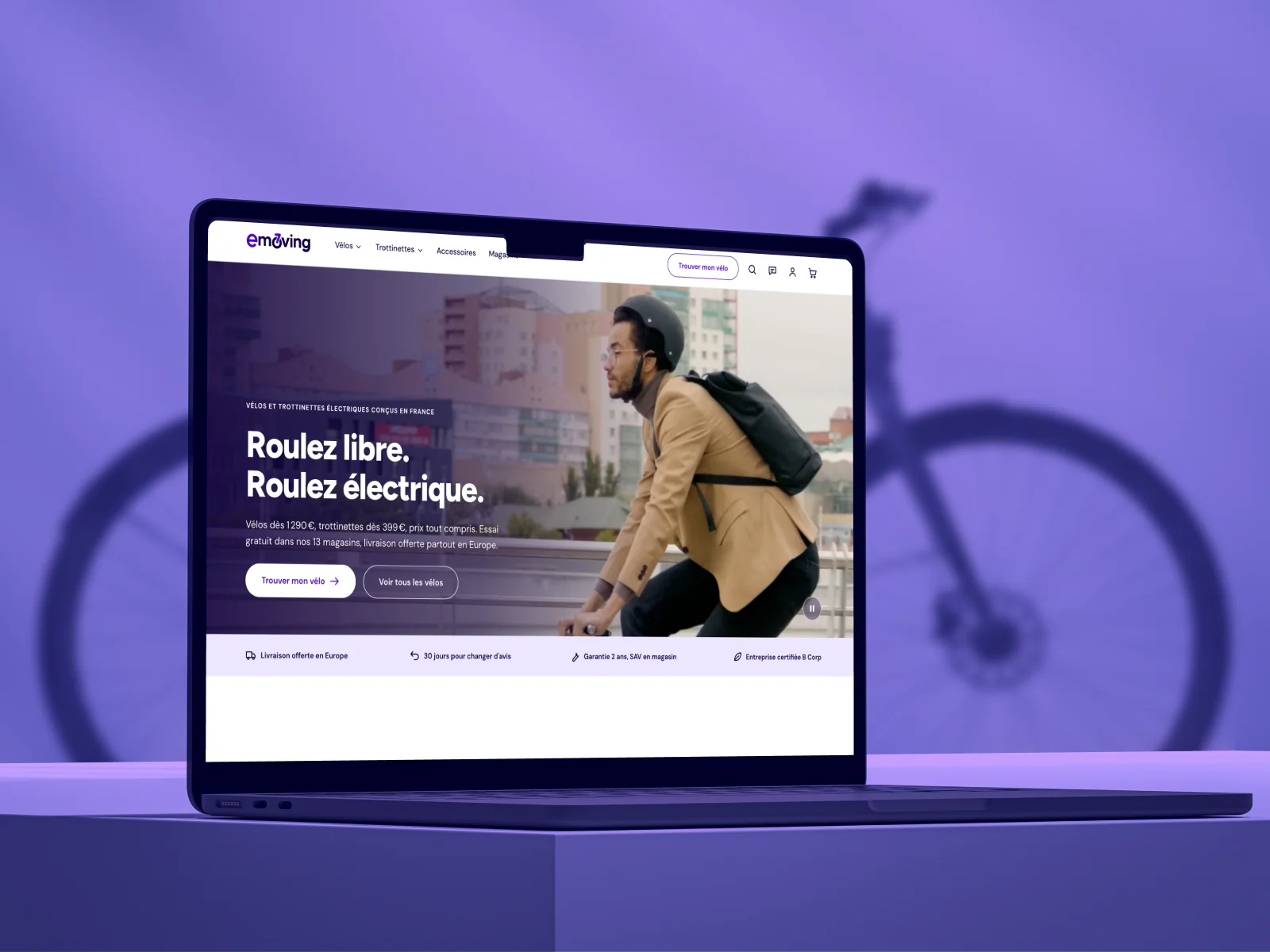The new Emoving website on a laptop, in front of an e-bike on a purple background